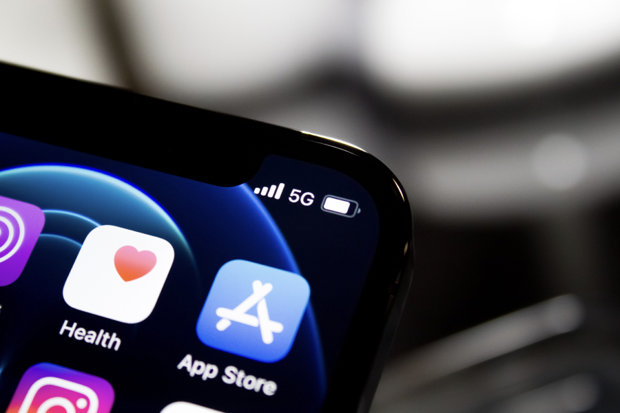 Close-up of an iPhone screen corner showing Health and App Store icons, with 5G signal indicator.