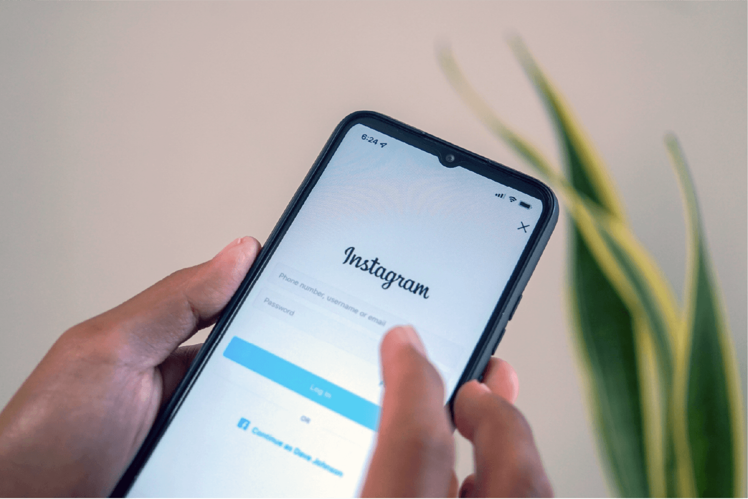social media: holding phone with instagram login